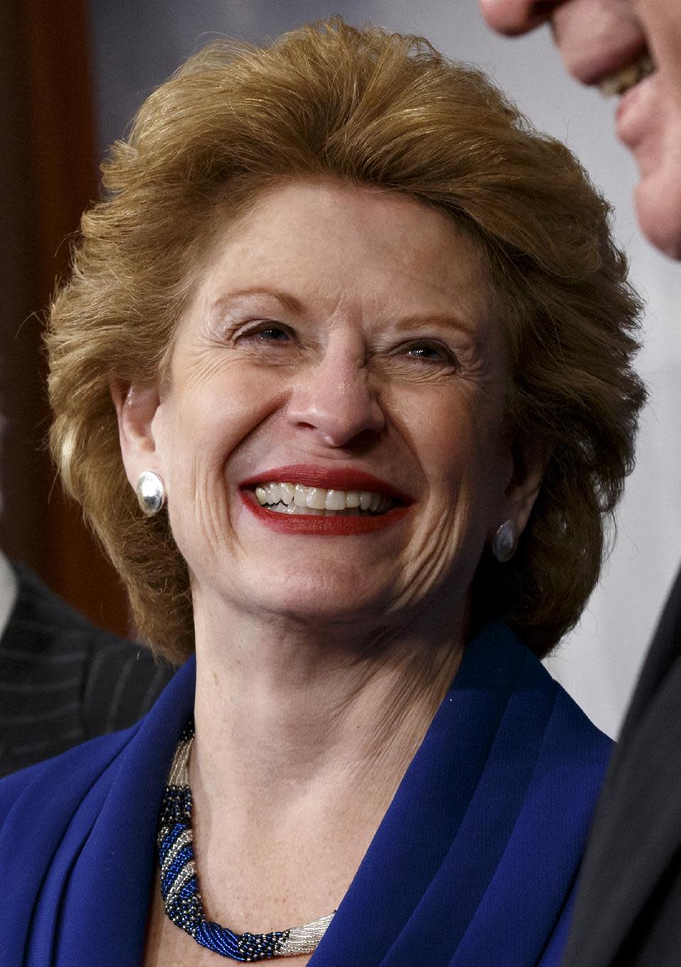 FILE - In this Feb 4, 2014 file photo, Senate Agriculture Committee Chair Sen. Debbie Stabenow, D-Mich., is seen during a news conference on Capitol Hill in Washington, Tuesday, Feb. 4, 2014, after Congress gave its final approval to a sweeping five-year farm bill. When President Barack Obama comes to East Lansing on Friday to sign the Farm Bill, it will put attention on how research schools such as Michigan State University will be one of the big beneficiaries of the nearly $100 billion-a-year measure — even if the millions it represents is comparatively small. And scientists are breathing a sigh of relief that funding will continue flowing, along with money for new efforts, after years of political wrangling. (AP Photo/J. Scott Applewhite)