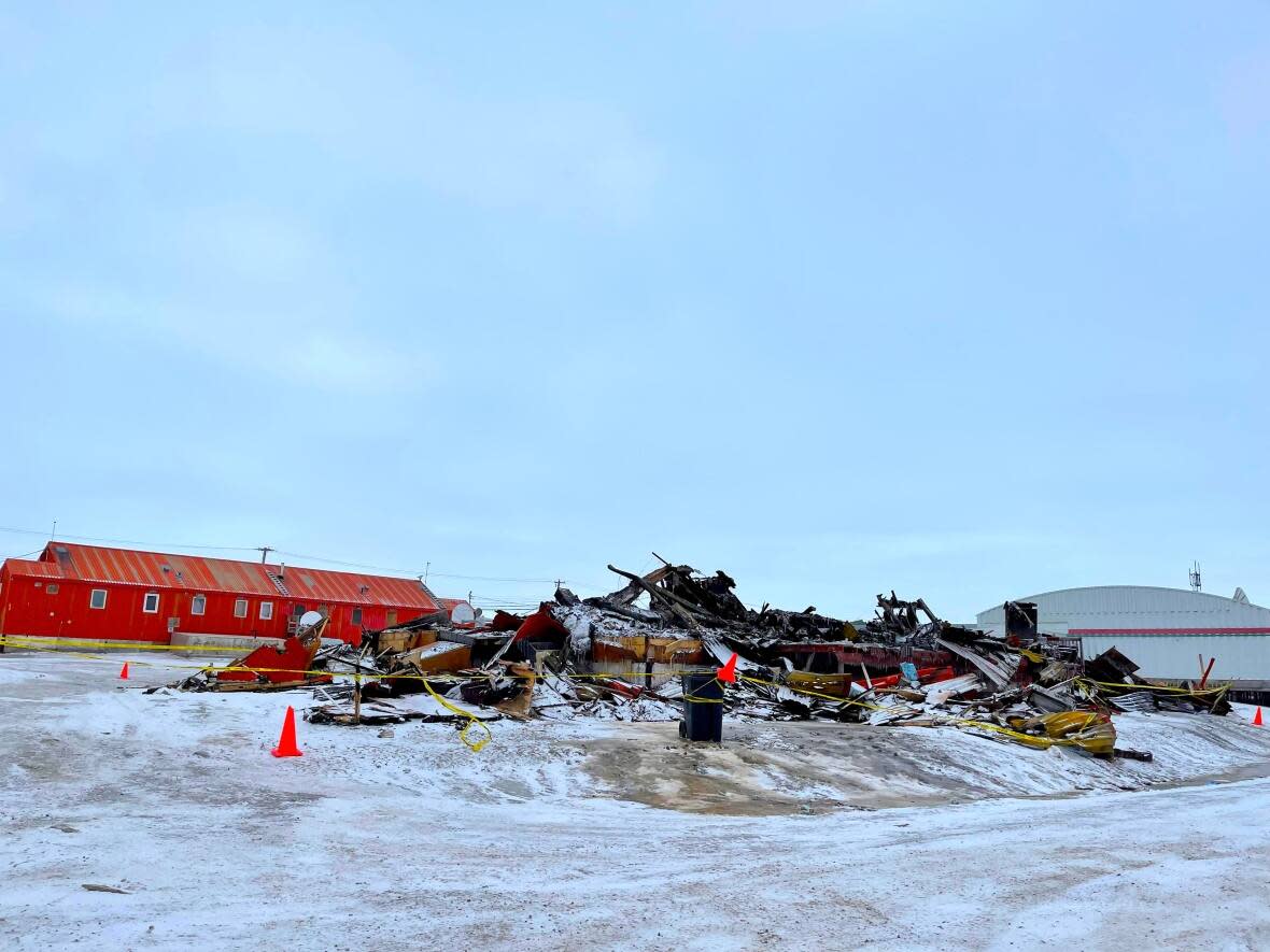 The remains of the Cambridge Bay youth centre after a fire destroyed the building earlier this week. The hamlet's chief administrative officer likened the loss to the community to Toronto losing the Air Canada Centre.  (Jane George/CBC - image credit)