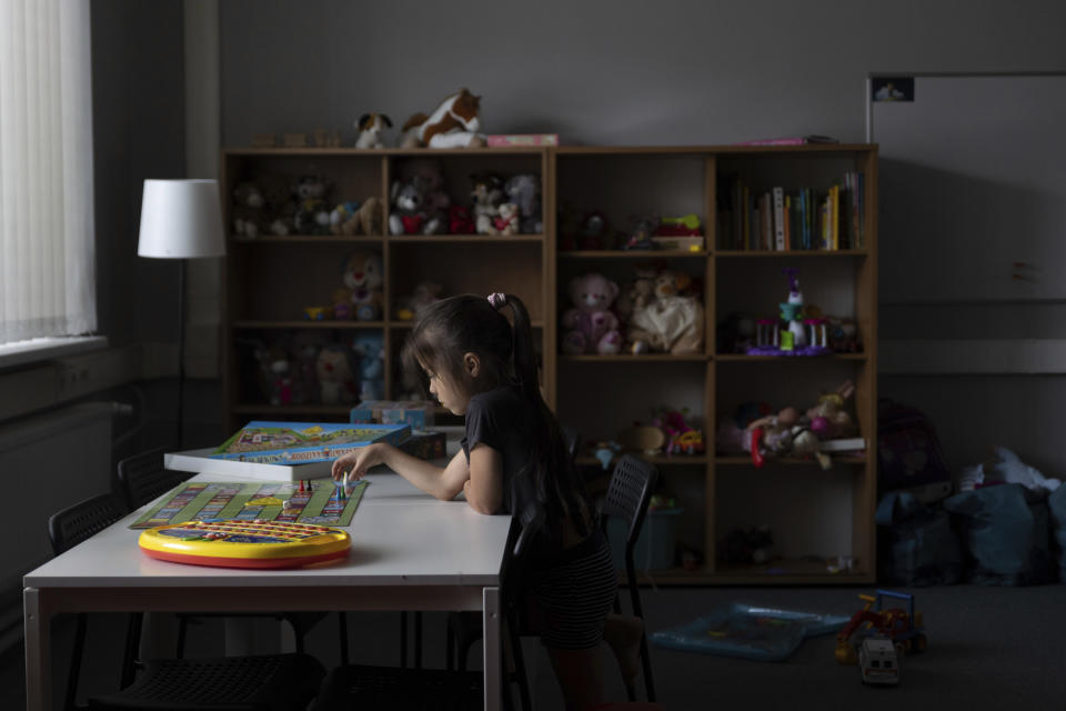 A young Ukrainian refugee child plays a board game at a refugee shelter in Warsaw, Poland, Wednesday, Aug. 17, 2022. As Russia’s war against Ukraine reaches the sixth-month mark, many refugees are coming to the bitter realization that they will not be returning home soon. With shelling around a nuclear power plant and missiles threatening even western regions of Ukraine, many refugees don’t feel safe at home, even if those areas are under Ukrainian control. (AP Photo/Michal Dyjuk)