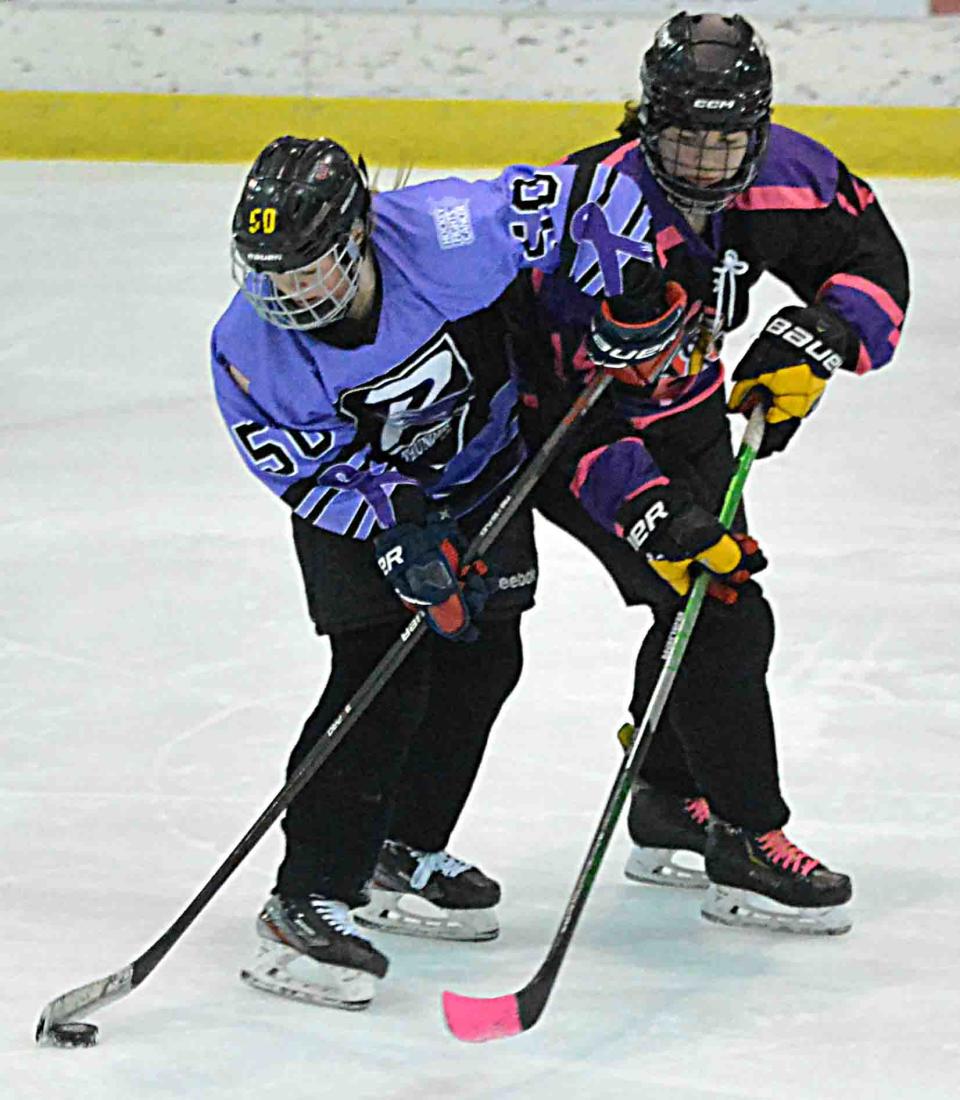 Rachel Skott of the Watertown Lakers (14) defends against Lillie Hoffman of the Rushmore Thunder during their South Dakota Amateur Hockey Association varsity girls hockey game on Saturday, Jan. 20, 2024 in the Maas Ice Arena. The Thunder won 6-3.