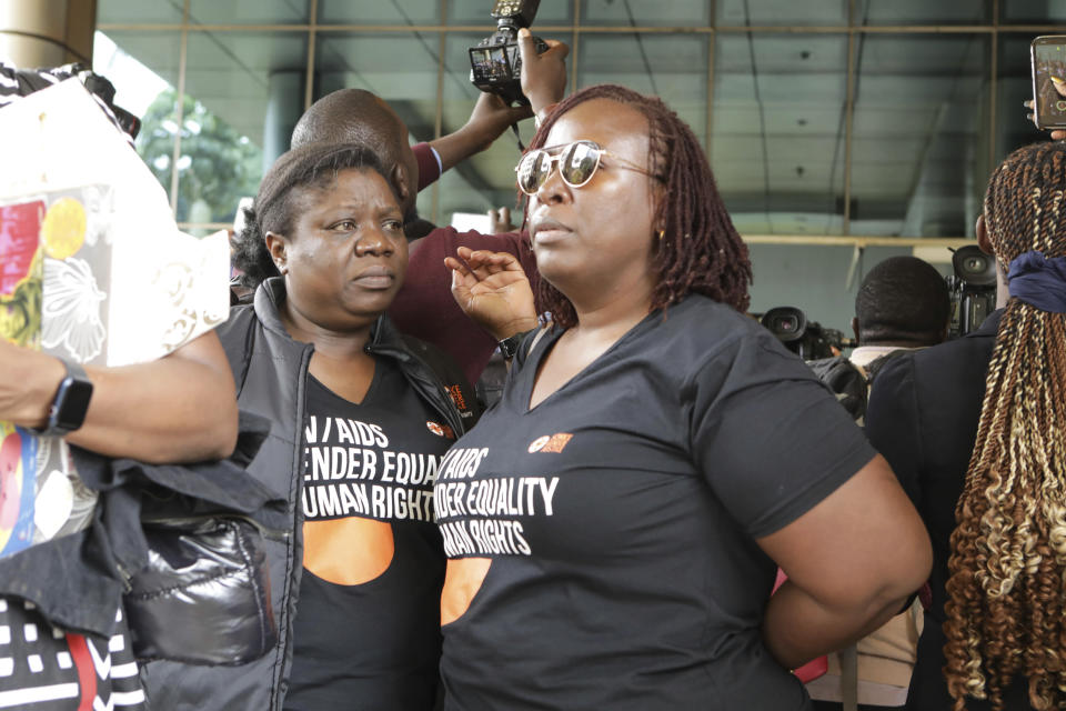 Human rights activists stand outside the Constitutional Court in Kampala, Uganda, Wednesday, April 3, 2024, as Uganda's Constitutional Court gives its seal of approval on the anti-homosexuality law, declaring that the Anti Homosexuality Act of 2023 complies with the Constitution of Uganda. (AP Photo/Hajarah Nalwadda )