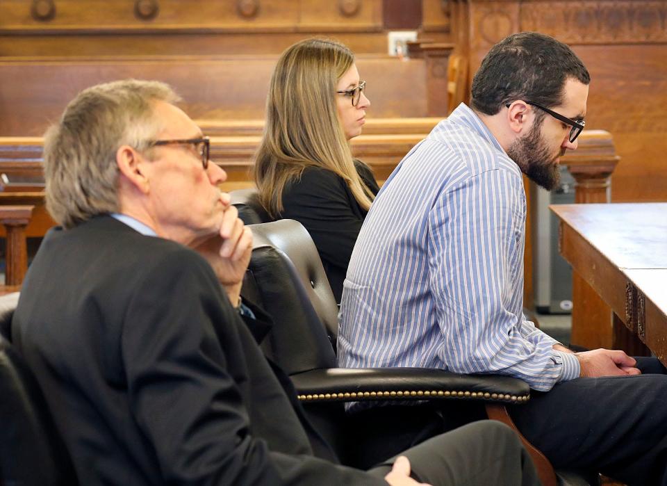 Murder suspect Emanuel Lopes, right, with his lawyers Larry Tipton and Christie Feeney, wait in Dedham Superior Court on Monday, Feb. 12, 2024. The jury said it was deadlocked.