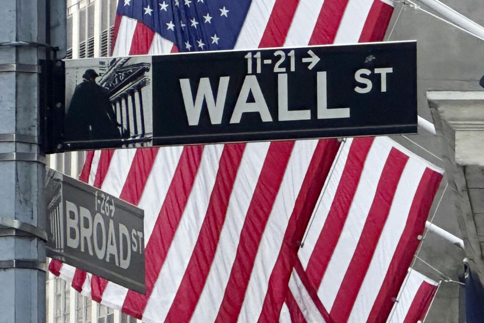 American flags fly on the front of the New York Stock Exchange near the intersection of Broad and Wall Streets on Wednesday, May 22, 2024, in New York. Markets on Wall Street were mixed early Wednesday but remain at or above record levels as more results from retailers take center stage amid a dearth of economic news. (AP Photo/Peter Morgan)