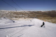 A snowboarder slides down the slope of the Afriski ski resort near Butha-Buthe, Lesotho, Saturday July 30, 2022. While millions across Europe sweat through a summer of record-breaking heat, Afriski in the Maluti Mountains is Africa's only operating ski resort south of the equator. It draws people from neighboring South Africa and further afield by offering a unique experience to go skiing in southern Africa. (AP Photo/Jerome Delay)