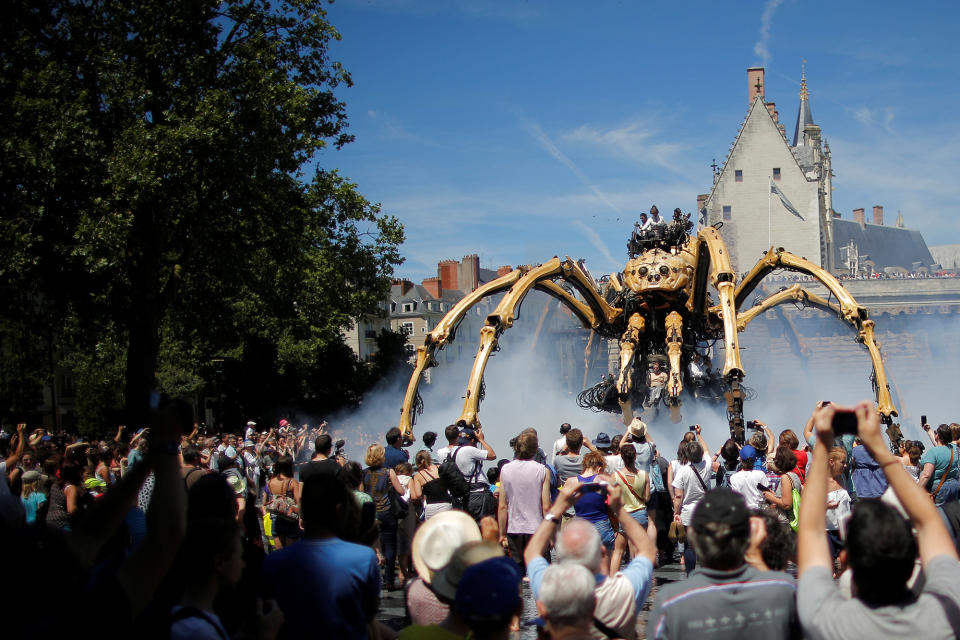 People look at the giant mechanical spider