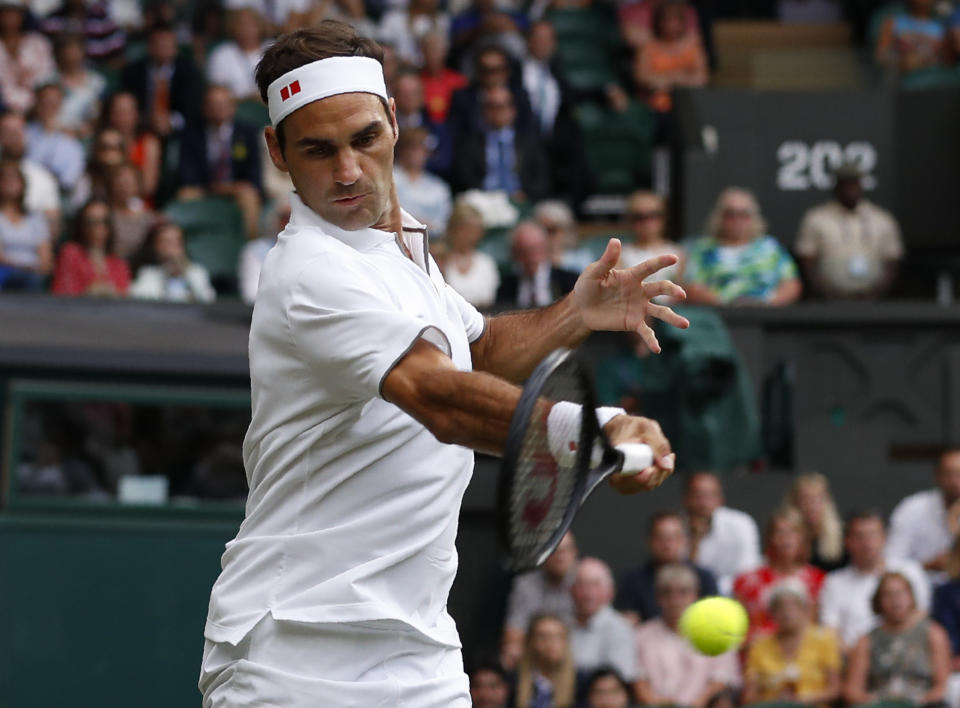 Switzerland's Roger Federer returns the ball to Italy's Matteo Berrettini in a men's singles match during day seven of the Wimbledon Tennis Championships in London, Monday, July 8, 2019. (AP Photo/Alastair Grant)