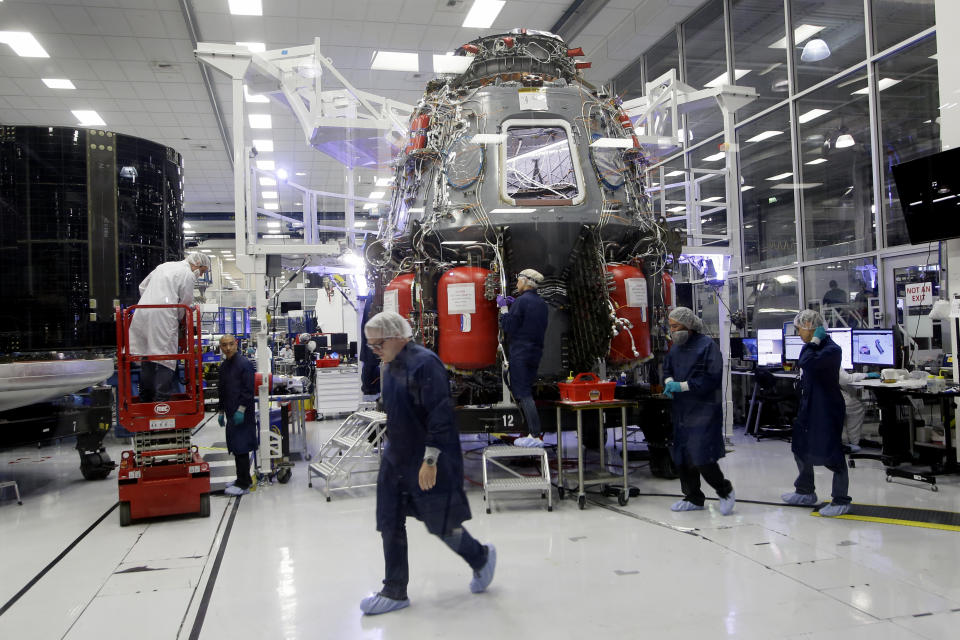 SpaceX employees work on the Crew Dragon spacecraft that will astronauts to and from the International Space Station, from American soil, as part of the agency's commercial crew Program, in Hawthorne, Calif., Thursday, Oct. 10, 2019. (AP Photo/Alex Gallardo)