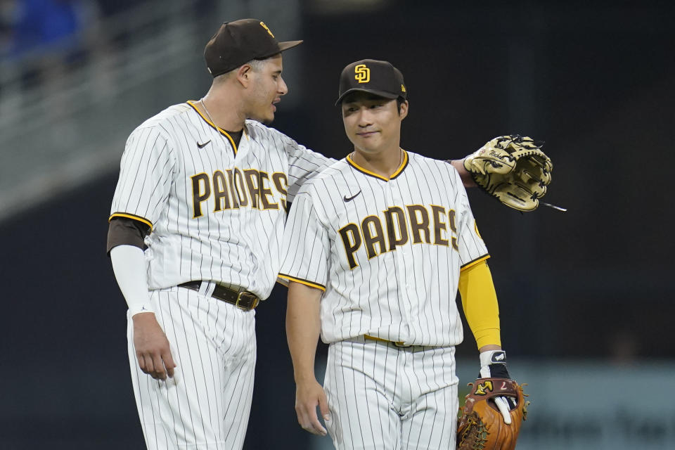 San Diego Padres third baseman Manny Machado, left, talks with shortstop Ha-Seong Kim during the fourth inning of the team's baseball game against the Los Angeles Dodgers, Thursday, Sept. 29, 2022, in San Diego. (AP Photo/Gregory Bull)