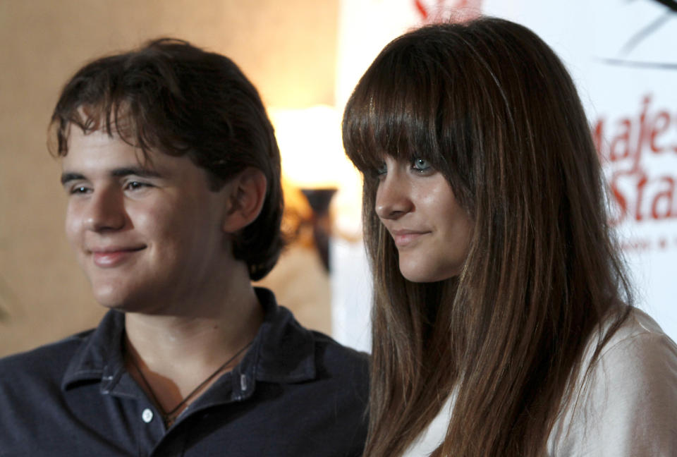 Prince, left, and Paris Jackson, children of the late pop icon Michael Jackson, pose for photographers after an appearance at a Jackson tribute event Wednesday, Aug. 29, 2012, in Gary, Ind. Members of Michael's family are in the Northwestern Indiana city on what would have been Jackson's 54th birthday. (AP Photo/Charles Rex Arbogast)