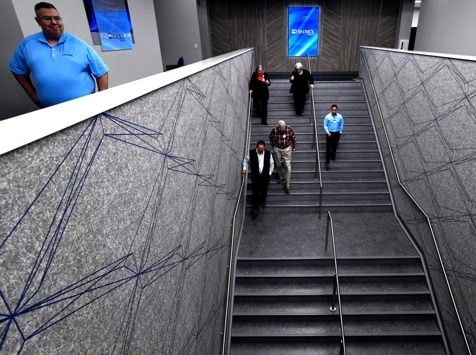 Visitors descend a staircase Thursday during tours of the newly opened Hendrick Service Center. Housed in the former Sears department store in the Mall of Abilene, the staircase is located where the store’s escalator used to be.