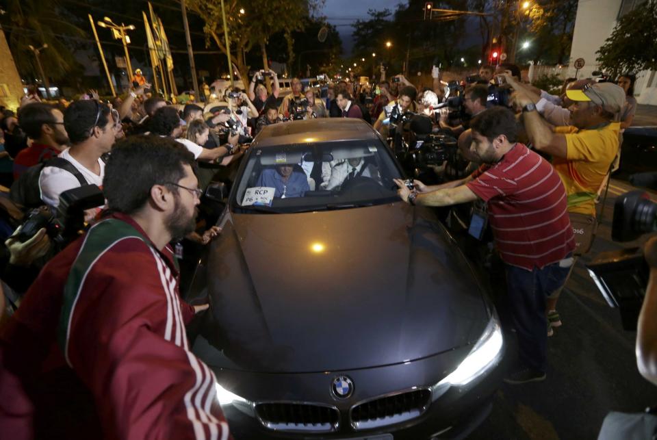 Reporters mob a car carrying American swimmers Jack Conger and Gunnar Bentz. (Reuters)