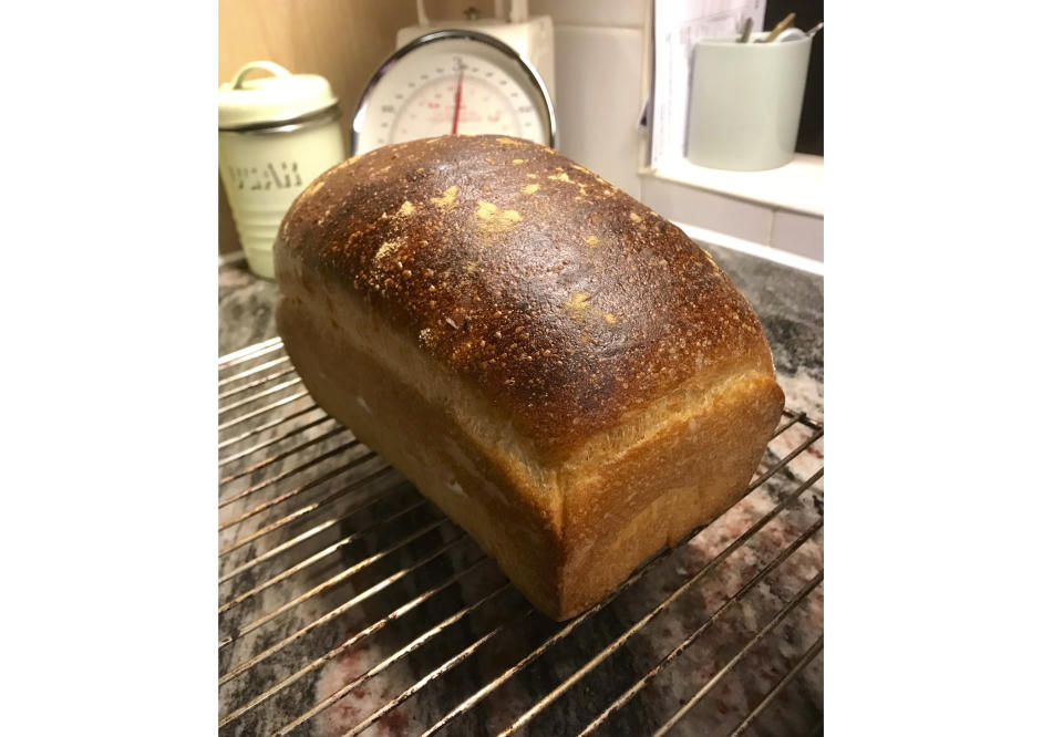 A freshly-baked loaf of white bread cools off on a wire rack at a home in London. With millions of people across the globe working at home due to lockdown measures imposed during the coronavirus pandemic, many people are choosing to make their own bread, rather than venturing to the local store to buy their weekly fix. (Matt Kemp via AP)