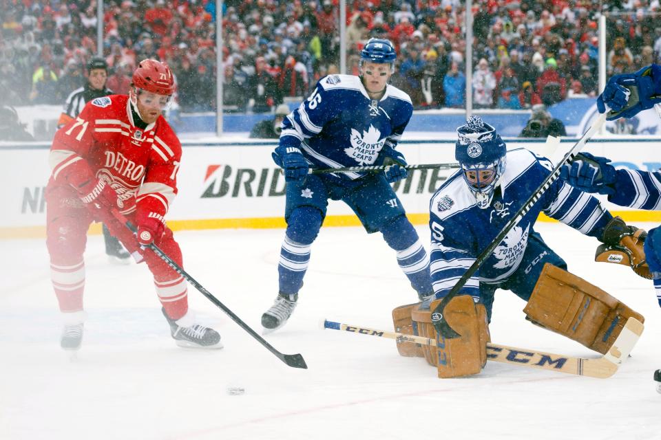 Jan 1, 2014; Ann Arbor, MI, USA; Detroit Red Wings right wing Daniel Cleary (71) gets behind Toronto Maple Leafs goalie Jonathan Bernier (45) during the 2014 Winter Classic hockey game at Michigan Stadium. Mandatory Credit: Rick Osentoski-USA TODAY Sports