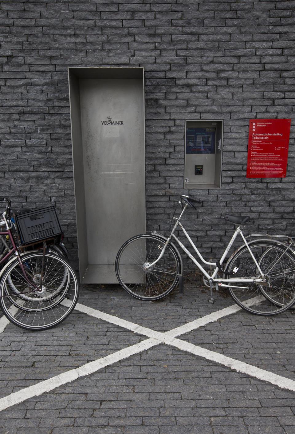 Parked bicycles block the entrance to a 50-place underground bicycle parking in Amsterdam Noord, across IJ river, Netherlands, Wednesday Oct. 31, 2012. (AP Photo/Peter Dejong)