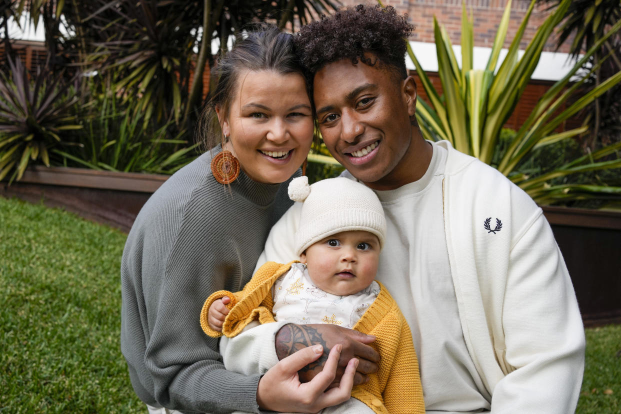 Ellia Green with his partner Vanessa Turnbull-Roberts and their daughter Waitui pose in Sydney, Australia, Monday, Aug. 15, 2022. Green, one of the stars of Australia's gold medal-winning women's rugby sevens team at the 2016 Olympics, has transitioned to male. The 29-year-old, Fiji-born Green is going public in a video at an international summit aimed at ending transphobia and homophobia in sport. The summit is being hosted in Ottawa as part of the Bingham Cup rugby tournament. (AP Photo/Mark Baker)