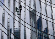 French urban climber Alain Robert, well known as "Spiderman", climbs up the 'Skyper' highrise in Frankfurt, Germany, Saturday, Sept. 28, 2019. (AP Photo/Michael Probst)