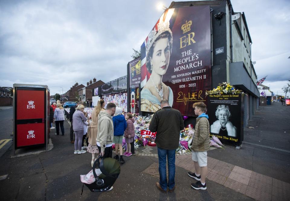 Members of the public visit a mural to the Queen on the Shankill Road (Liam McBurney/PA) (PA Wire)