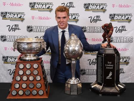 Jun 21, 2017; Las Vegas, NV, USA; Edmonton Oilers forward Connor McDavid poses for a photo with the Art Ross Trophy, Hart Trophy and Ted Lindsay Award in the interview room during the 2017 NHL Awards and Expansion Draft at T-Mobile Arena. Mandatory Credit: Stephen R. Sylvanie-USA TODAY Sports