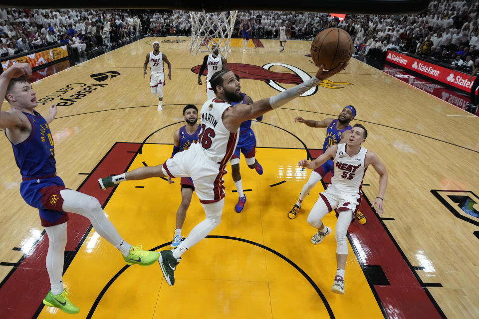 Miami Heat forward Caleb Martin (16) drives to the basket during the first half of Game 3 of NBA Finals basketball game against the Denver Nuggets, Wednesday, June 7, 2023, in Miami. (AP Photo/Wilfredo Lee)