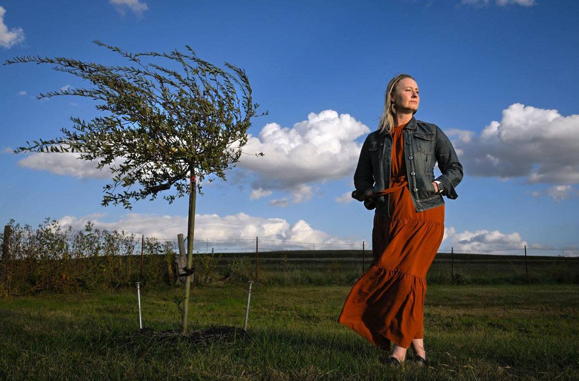 Vanessa Jackson of Leavenworth, Kansas, stands near a weeping willow tree planted in memory of her son, Caleb Jackson, 18, on the grounds of the family’s church, High Prairie Gospel Church, in Leavenworth, Kansas. Caleb Jackson, 18, who Vanessa and her husband, Todd Jackson, adopted as a young child, died from fentanyl poisoning in March. Caleb was a beloved member of the church.