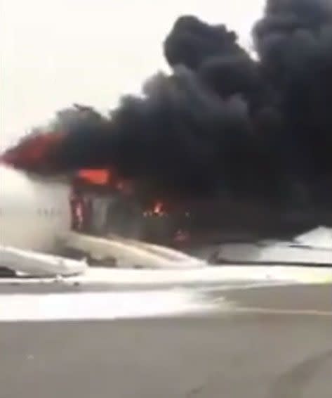 Thick, black plumes of smoke are seen billowing out of the aircraft. Photo: Twitter