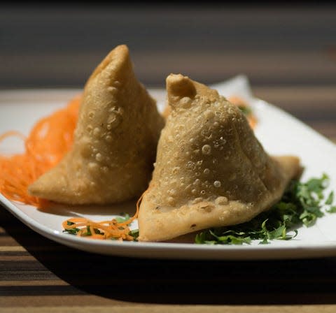 Aangan India Bistro serves samosas filled with vegetables or spiced chicken.