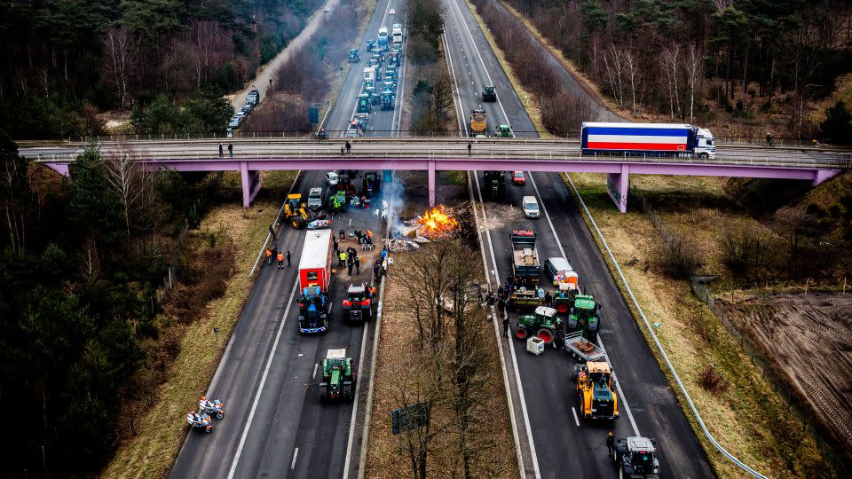 Dutch and Belgian farmers take part in a road blockade near the border crossing between Belgium and the Netherlands, in Arendonk. - Rob Engelaar/ANP/AFP via Getty Images