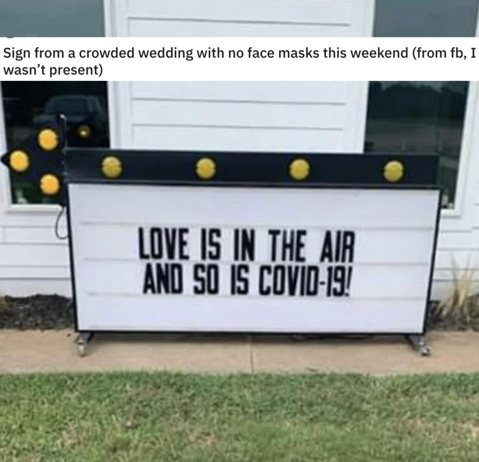 The sign outside the venue says "love is in the air and so is COVID-19"