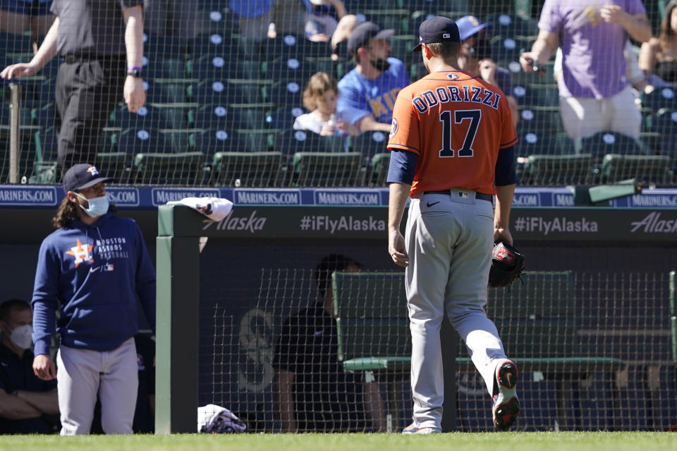 Houston Astros starting pitcher Jake Odorizzi walks to the dugout after being pulled from a game against the Seattle Mariners during the fifth inning of a baseball game, Sunday, April 18, 2021, in Seattle. (AP Photo/Ted S. Warren)