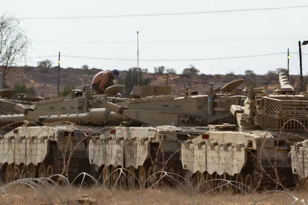 A soldier works on a tank on 31 October 2023 in Southern Israel (Getty Images)