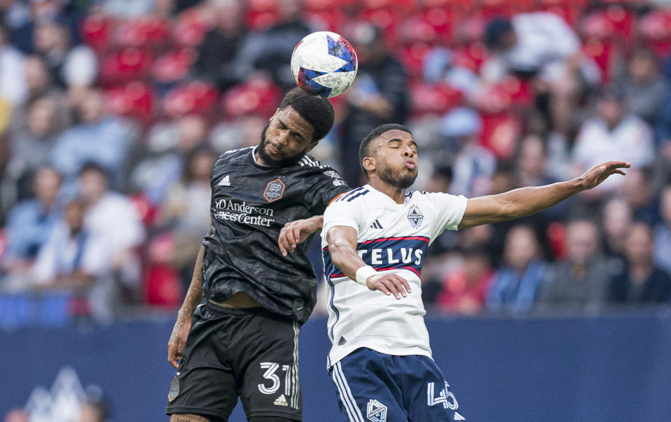 Vancouver Whitecaps' Pedro Vite, right, and Houston Dynamo's Micael compete for a head ball during the first half of an MLS soccer match Wednesday, May 31, 2023, in Vancouver, British Columbia. (Rich Lam/The Canadian Press via AP)