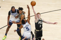 Atlanta Hawks guard Kevin Huerter (3) and Minnesota Timberwolves guard Malik Beasley (5) battle for a jump ball in the first half of an NBA basketball game on Monday, Jan. 18, 2021, in Atlanta. (AP Photo/Todd Kirkland)