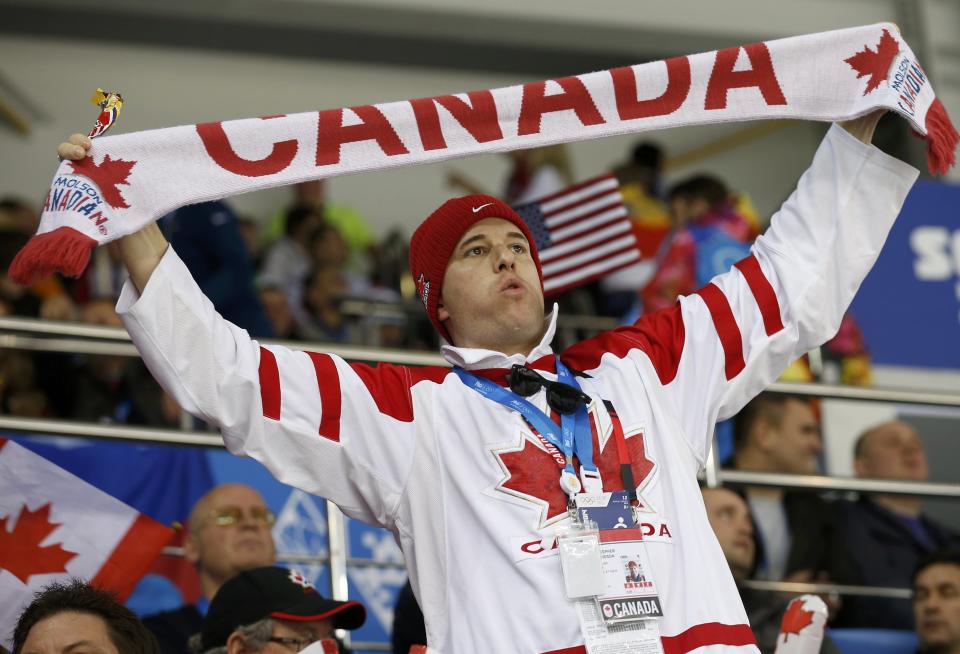 Team Canada women's ice hockey team fan waits for game against Team USA at the 2014 Sochi Winter Olympics