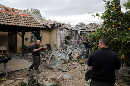 Police sappers inspect a damaged house that was hit by a rocket north of Tel Aviv Israel March 25, 2019. REUTERS/ Ammar Awad