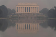 The Lincoln Memorial is seen reflected in the reflecting pool at the national mall with a thick layer of smoke covering, on Thursday, June 8, 2023, in Washington. Intense Canadian wildfires are blanketing the northeastern U.S. in a dystopian haze, turning the air acrid, the sky yellowish gray and prompting warnings for vulnerable populations to stay inside. (AP Photo/Jose Luis Magana)