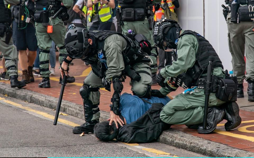 Riot police arrest a protestor in Hong Kong  - Anthony Kwan/Getty Images