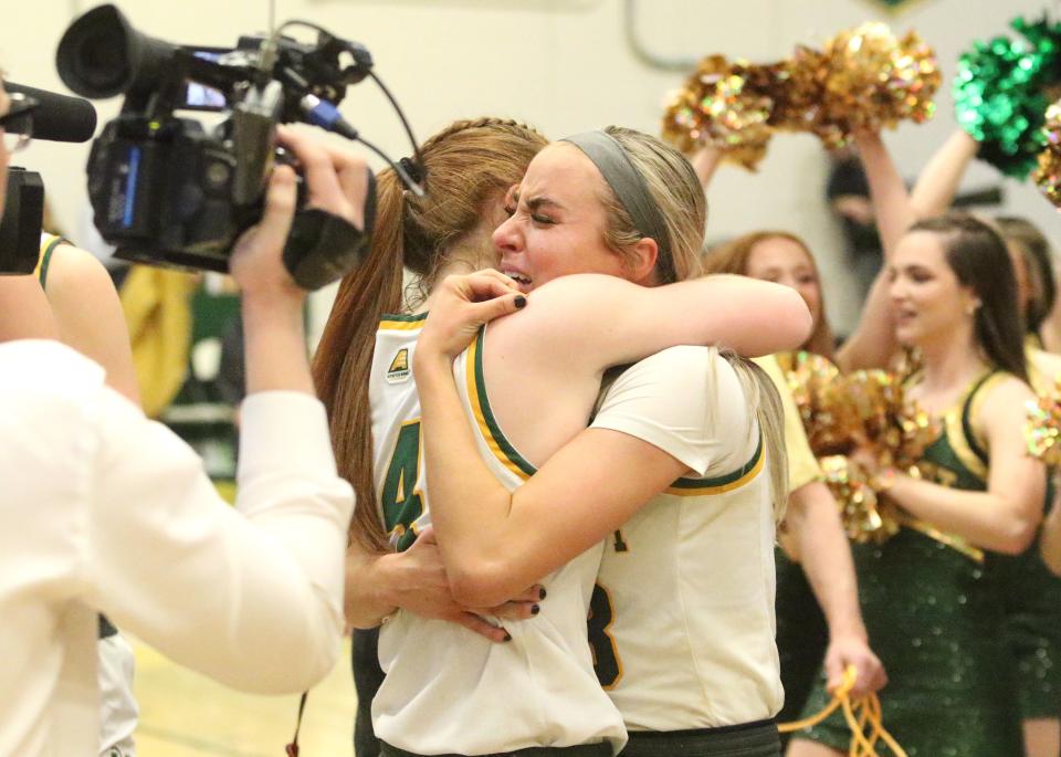 Vermont's Catherine Gilwee (left) and Emma Utterback share an emotional embrace moments after the Catamounts 38-36 win over Albany in the America East title game at Patrick Gym.