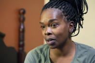 Ida Cartlidge sits on a bed in a two-bed motel room in Rolling Fork, Miss., on Nov. 29, 2023. After a deadly tornado destroyed their home in March 2023, the Cartlidge family of five spent nearly a year in the cramped motel room in search of a more permanent home, like many of their displaced neighbors. The town of Rolling Fork has struggled to rebuild after the tornado struck, killed 14 residents and reduced the town to rubble as it charted a merciless path across one of the country’s poorest regions. (AP Photo/Rogelio V. Solis)