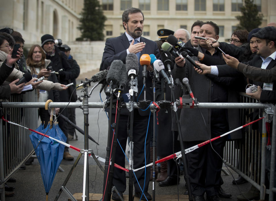 Louay Safi, center, spokesperson for the Syrian National Coalition, Syria's main political opposition group, is surrounded by journalists as he gives a brief statement at the United Nations headquarters in Geneva, Switzerland, Wednesday, Jan. 29, 2014. Syrian negotiators have resumed talks over the country's future a day after cutting short their discussions over a U.S. decision to resume aid to the opposition. (AP Photo/Anja Niedringhaus)