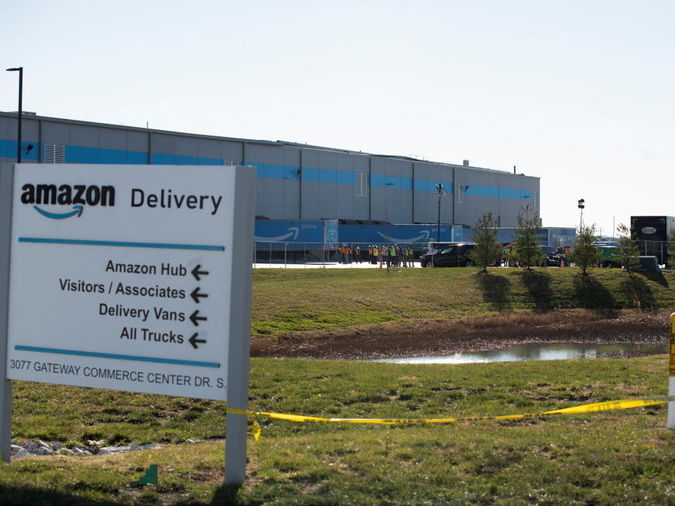 Amazon personnel gather for a meeting on the lot of the distribution center where the roof collapsed  in Edwardsville, Illinois, U.S. December 13, 2021.  REUTERS/Lawrence Bryant