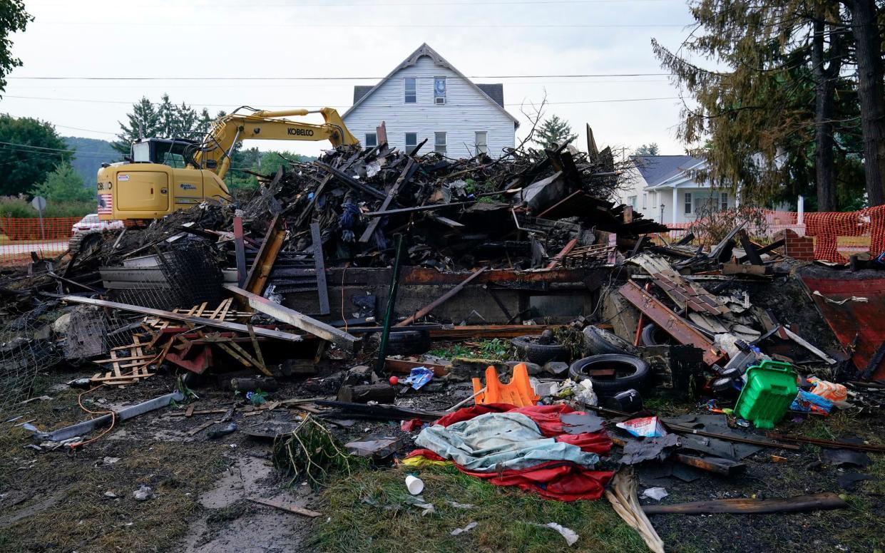 A house that was destroyed by a fatal fire is viewed in Nescopeck, Pa., Friday, Aug. 5, 2022. Multiple people are feared dead after the fire early Friday in northeastern Pennsylvania, according to a volunteer firefighter who responded and said the victims were his relatives. A criminal investigation is underway, police said. () - AP Photo/Matt Rourke