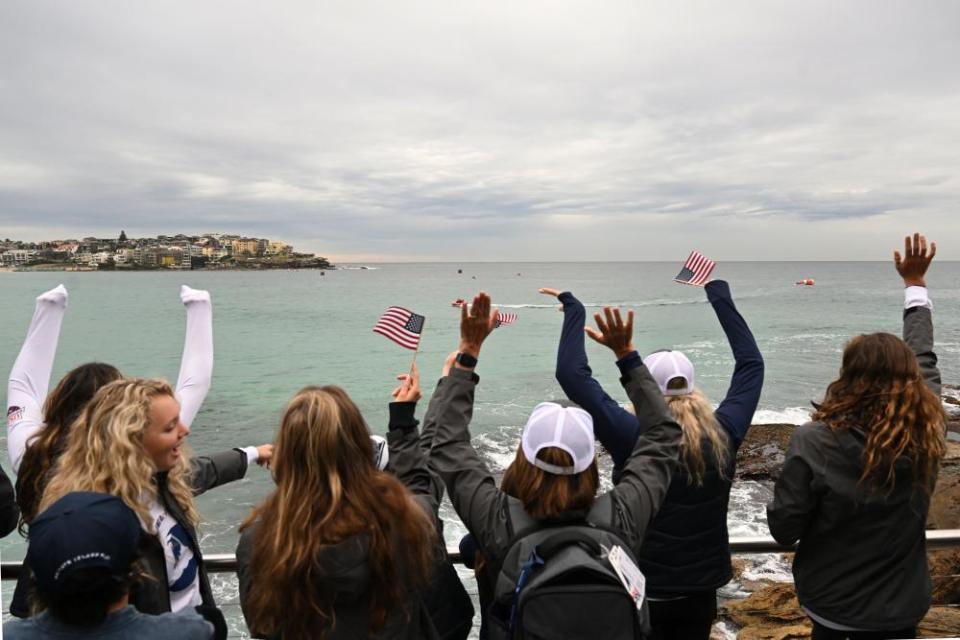 Team USA cheer on their teammates as they race across the bay.