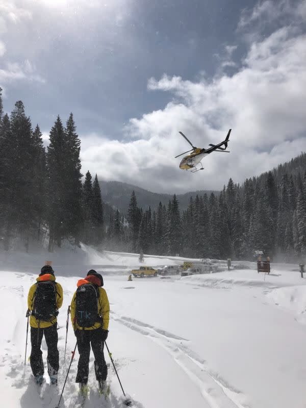 TCSAR volunteers watch the helicopter take off from Coal Creek, near the scene of a fatal avalanche in the Tetons.<p>Photo: TCSAR</p>
