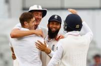 Britain Cricket - England v Pakistan - Second Test - Emirates Old Trafford - 25/7/16 England's Chris Woakes celebrates taking the wicket of Pakistan's Mohammad Amir with Stuart Broad, Moeen Ali and teammates Action Images via Reuters / Jason Cairnduff Livepic