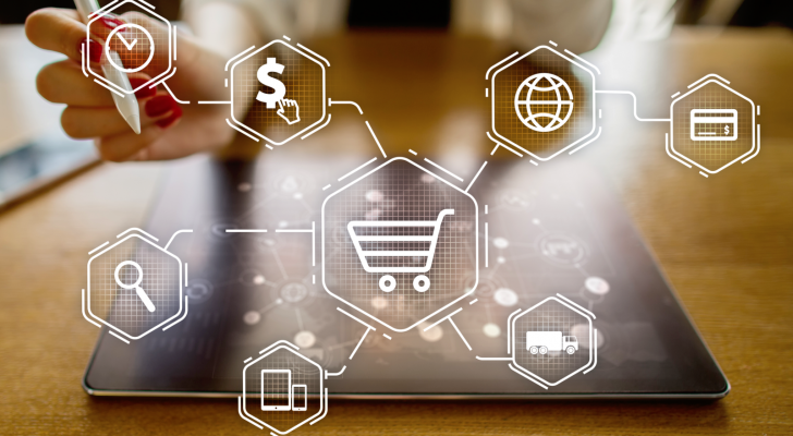 An image of a tablet with icons overlaid; magnifying glass, globe, shopping cart, money, truck