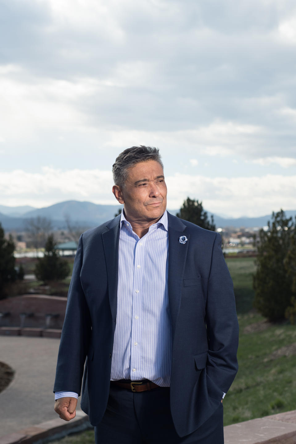 Kiki Leyba poses for a portrait at the Columbine Memorial site in Littleton, Colo. on April 18, 2019. Leyba was a teacher during the Columbine shootings. He has remained at the school during the last 20 years. Photograph by Theo Stroomer for TIME | Theo Stroomer for TIME