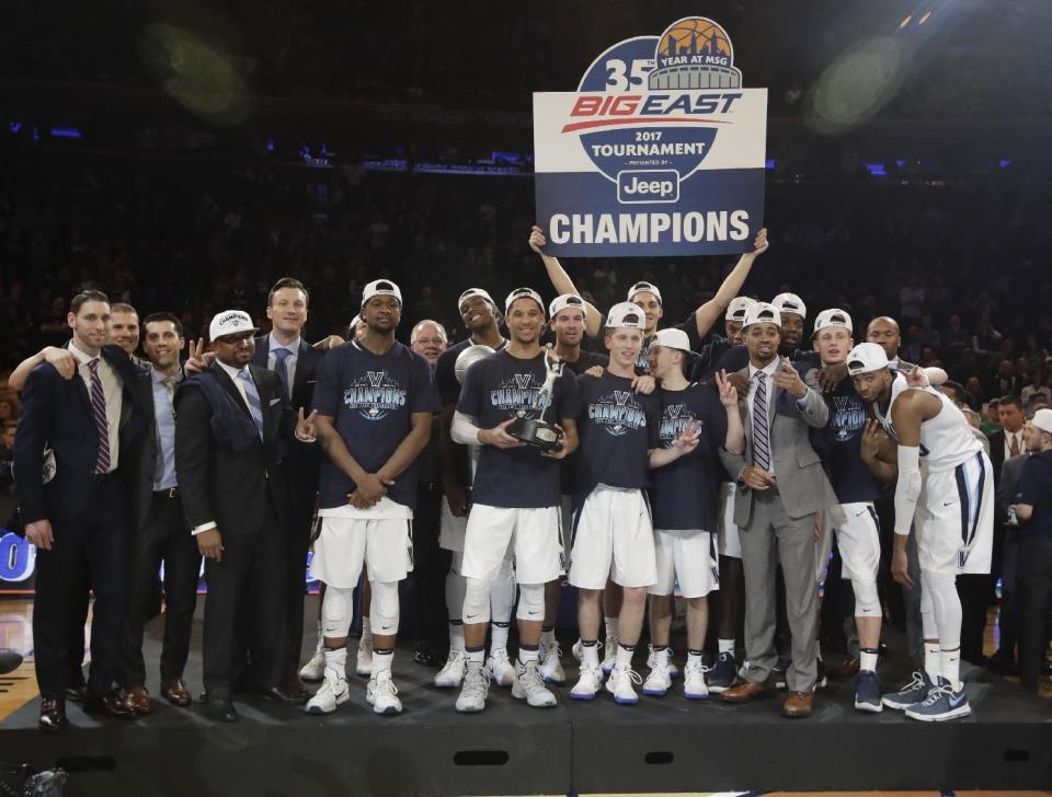 Villanova poses for photographs with the tournament trophy after a championship NCAA college basketball game against Creighton in the finals of the Big East men's tournament Saturday, March 11, 2017, in New York. Villanova won 74-60. (AP Photo/Frank Franklin II)