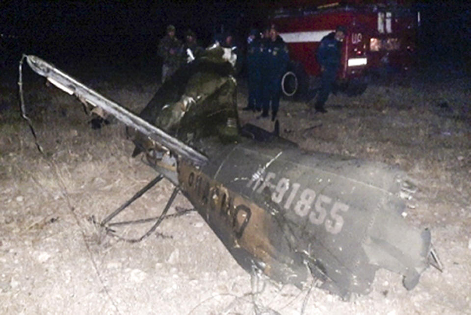 In this handout photo released by Armenian Emergency Ministry Press Office on Monday, Nov. 9, 2020, shows wreckage of a downed Russian military helicopter which was shot down in Armenia near the border with Azerbaijan. Two servicemen were killed, but the Russian Defense Ministry said the aircraft was outside the conflict area. The helicopter was downed near the border with Nakhcivan, an exclave of Azerbaijan surrounded by Armenia, Turkey and Iran. It was not clear who shot it down. (Armenian Emergency Ministry Press Office via AP)