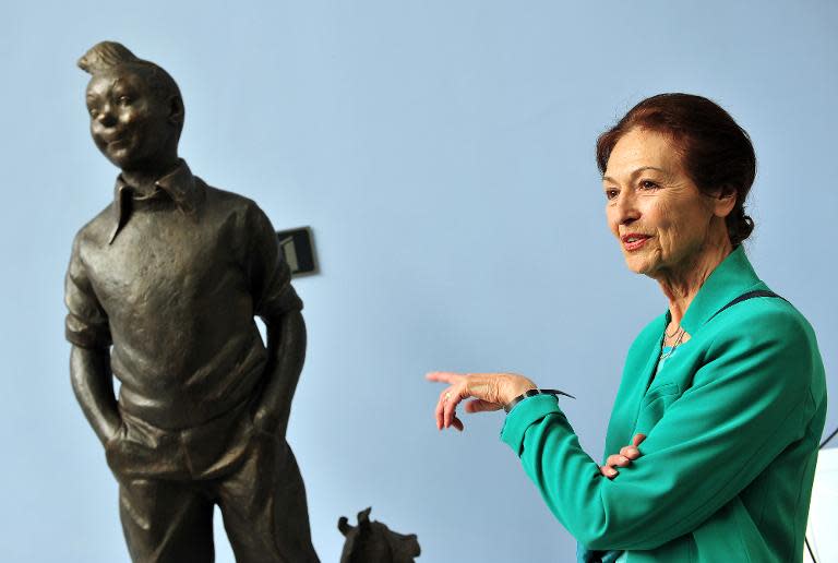 Fanny Rodwell, the widow of Herge, creator of comic book hero Tintin, poses next to a sculpture of Tintin on May 22, 2014 at the Herge museum in Louvain-La-Neuve