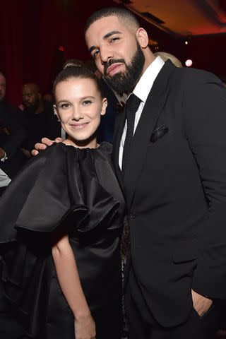 <p>Kevin Mazur/Getty</p> Drake and Millie Bobby Brown at the Golden Globes afterparty in January 2018